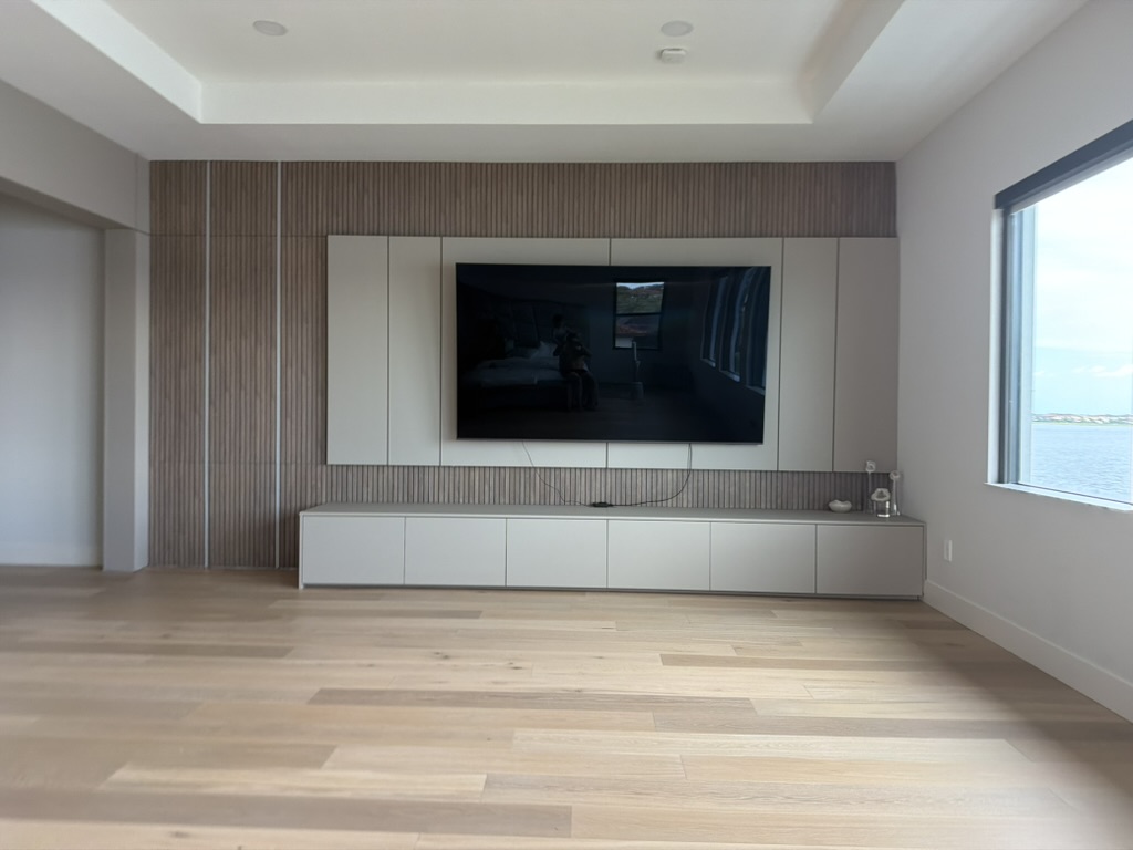 Slatted media wall and floating cabinetry