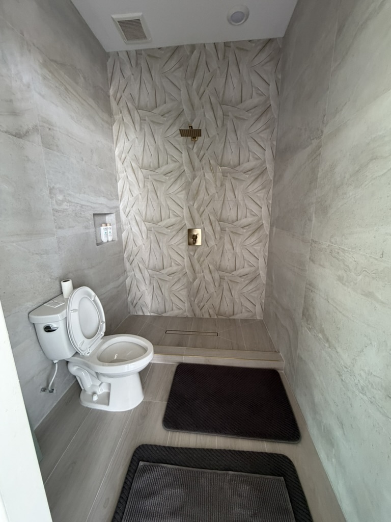 Textured shower tile and brass fixtures